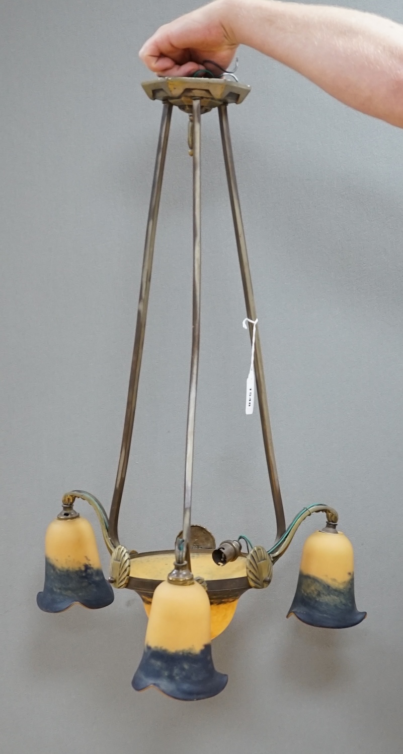 A French Art Deco brass three branch hanging light, with Muller Frere style glass shades, 75cm high. Condition - good